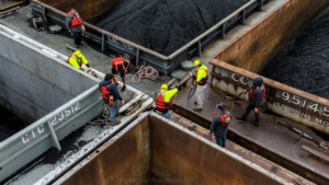 Drone aerial of coal barge workers