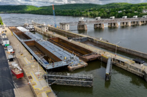 Drone aerial of barges navigating a lock near Pittsburgh