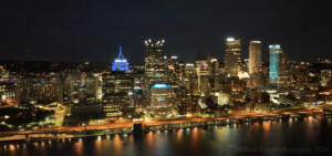 Drone cityscape of Pittsburgh at night.